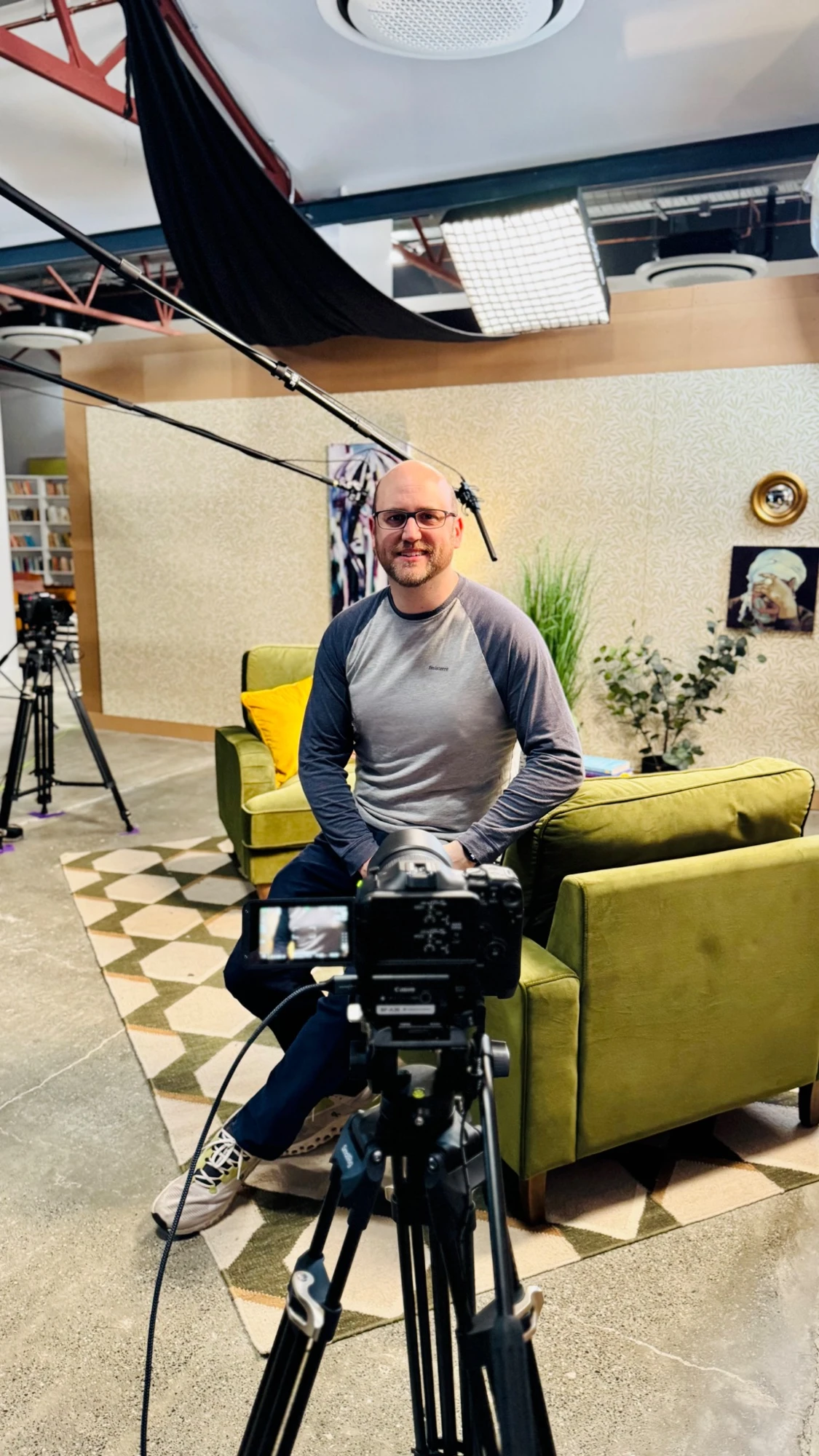 Ollie Kenchington on a podcast set, surrounded by cameras and studio lighting